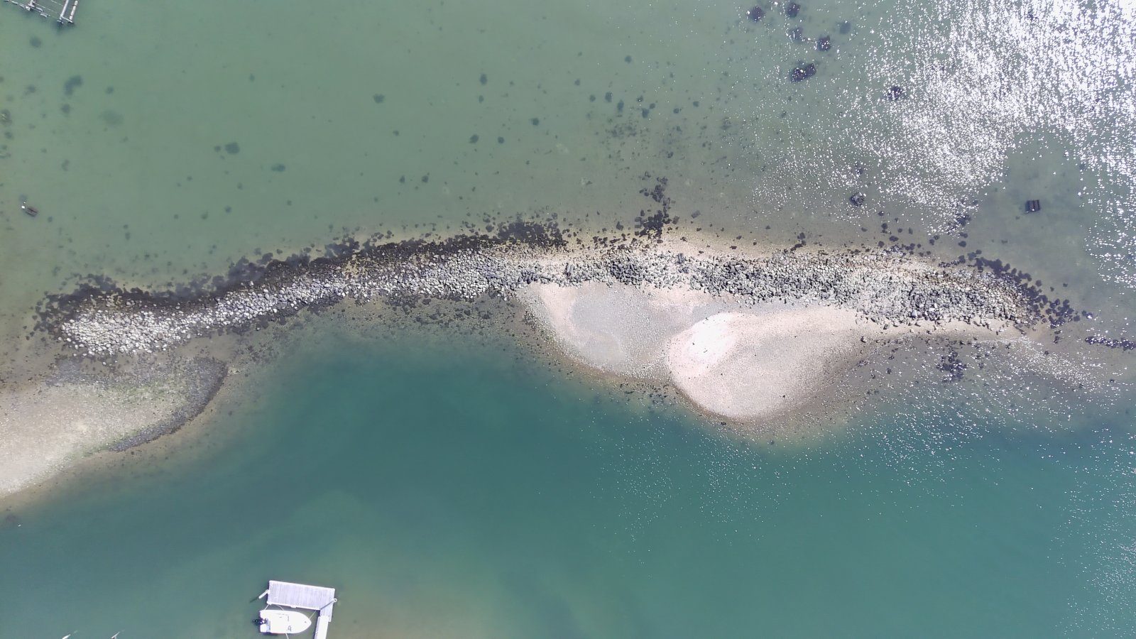 Aerial drone photo of the old, weathered rock jetty at Widow's Hole, September 2023