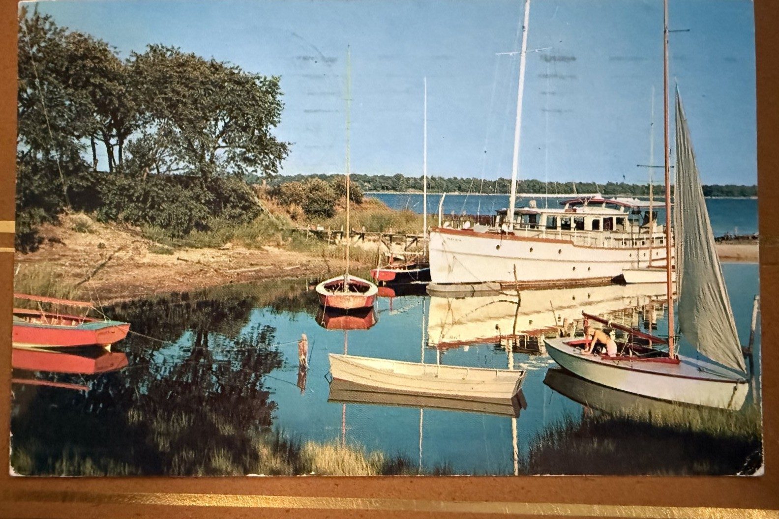 1950s color postcard: sloop and red skiffs at Widow's Hole