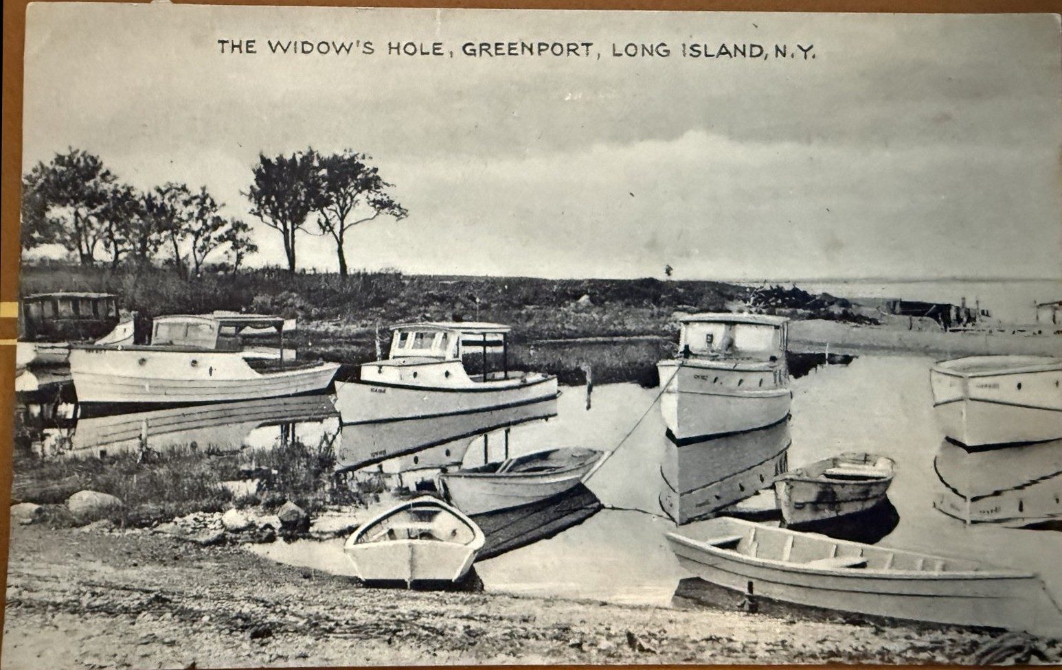 Postcard of many motorboats moored and hauled at Widow's Hole, 1920s-1940s
