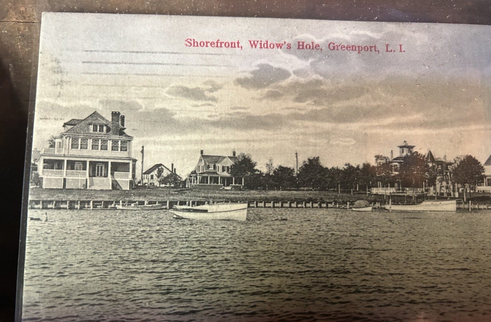 Hand-colored postcard, Shorefront, Widow's Hole, Greenport, showing bulkheaded shore and large houses